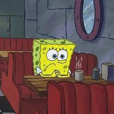 spongebob sits in silence in a booth with coffee, contemplating